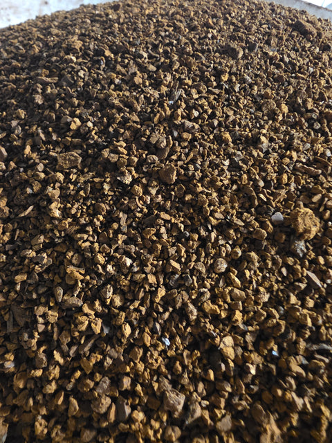 Wild chaga granules ground to 50 mesh in a bucket